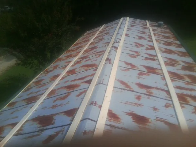 Rusted metal roof panels with new wood purlins before replacement — Storm Damage Roof Repair in Fort Monmouth by Roofing Brothers